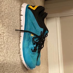 turquoise and yellow champion running shoes